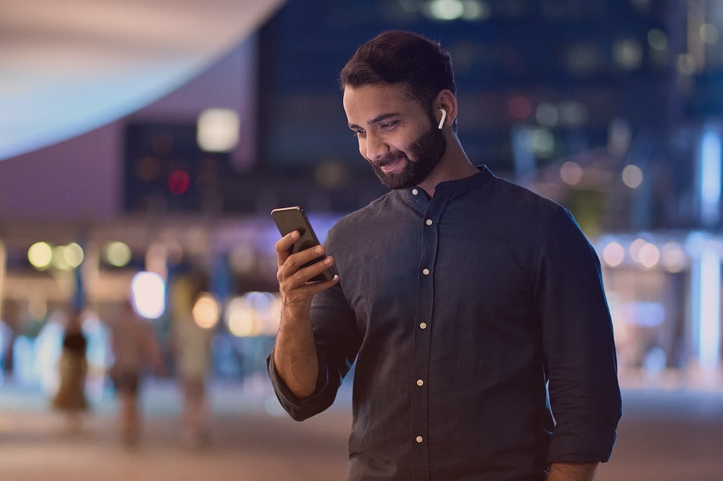 Image of man, very happy looking at his phone.